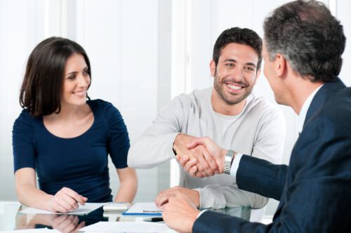 Banker shaking hands at a desk